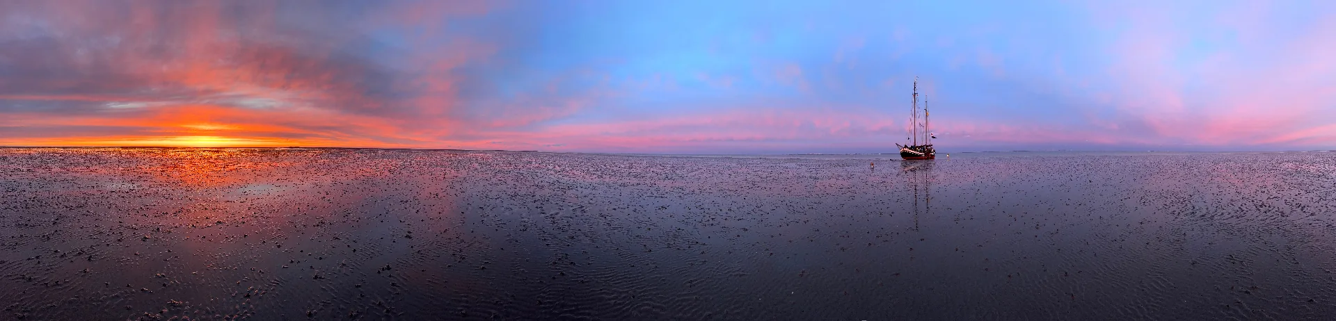 Panorama mudflats sunset with ship