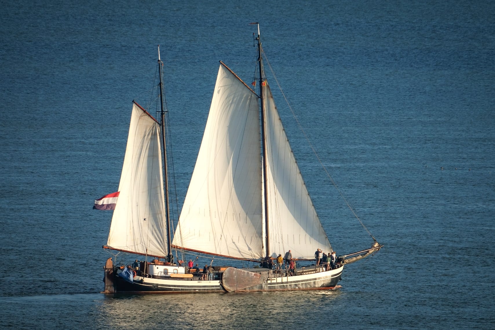 Minerva under full sail with Dutch flag